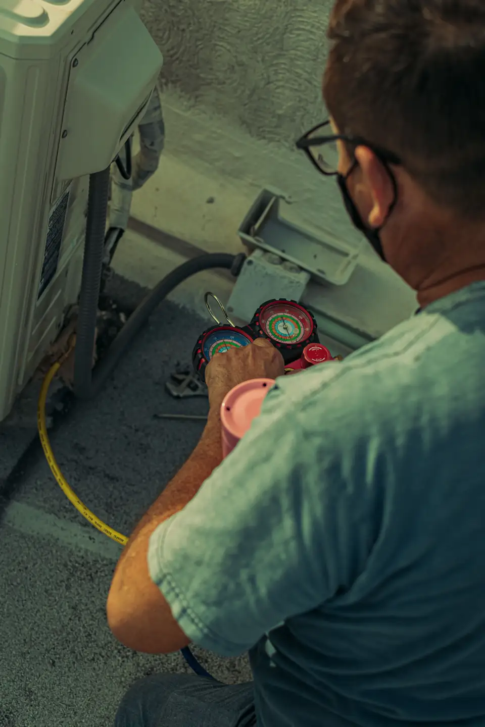 Stock view of a technician working on air-conditioning equipment